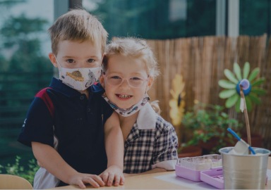 Boy and girl with masks during class