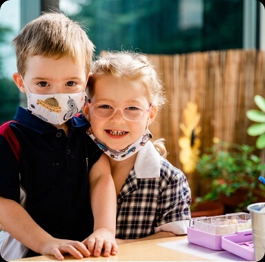 Boy and girl with masks during class